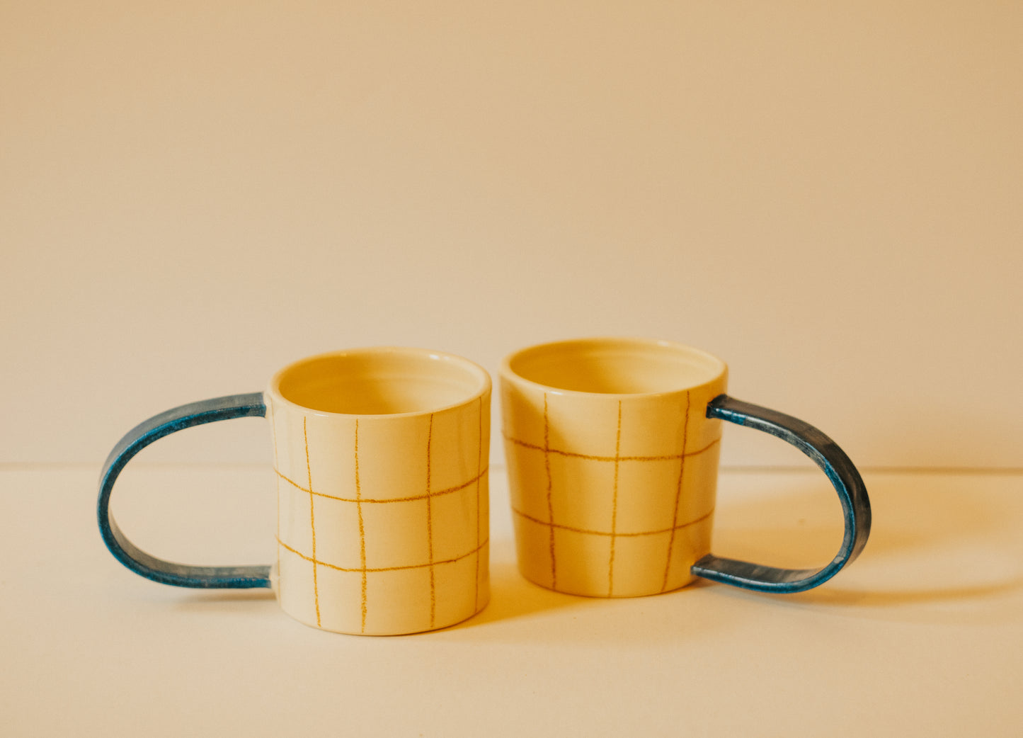 Checkered Mug With Blue Handle